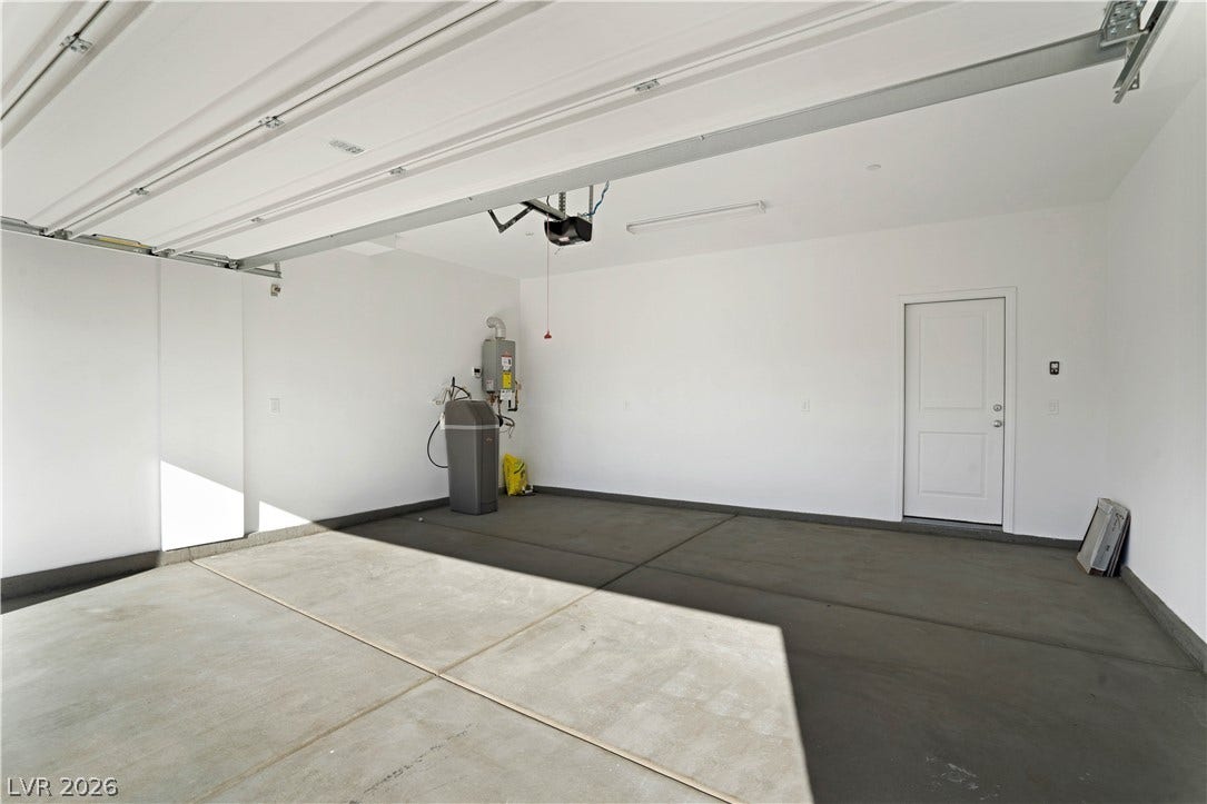 A spacious, pristine garage offers ample storage and direct home access