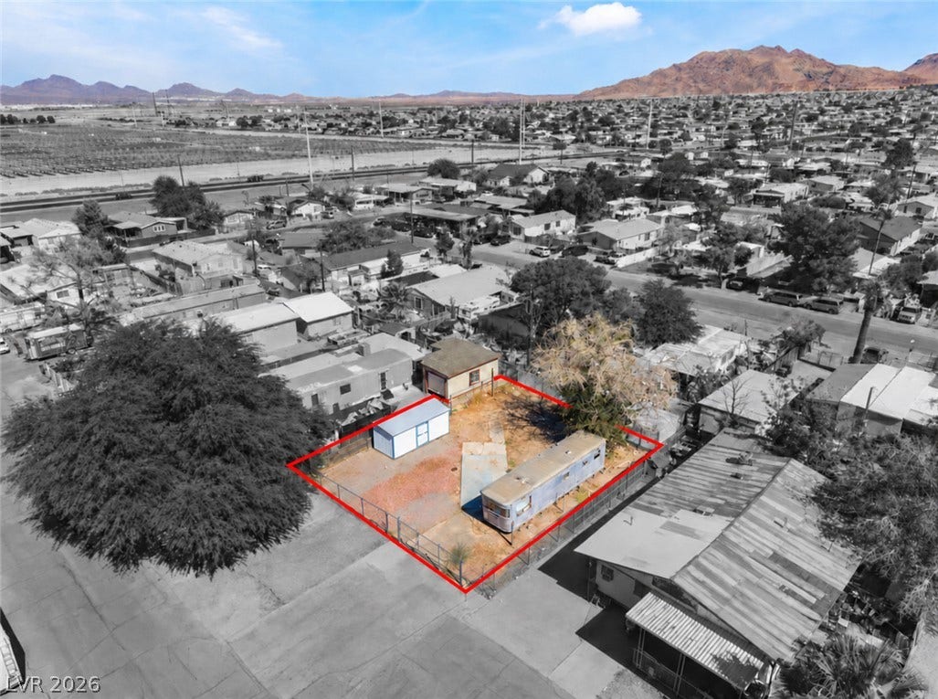 2268 Jo Anne Lane, Las Vegas, NV 89156 An aerial view highlights the fenced lot set against a scenic desert mountain backdrop.