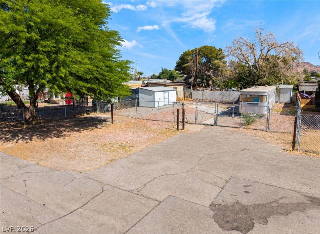 2268 Jo Anne Lane, Las Vegas, NV 89156 Mature trees shade a spacious outdoor area bordered by secure chain-link fencing.