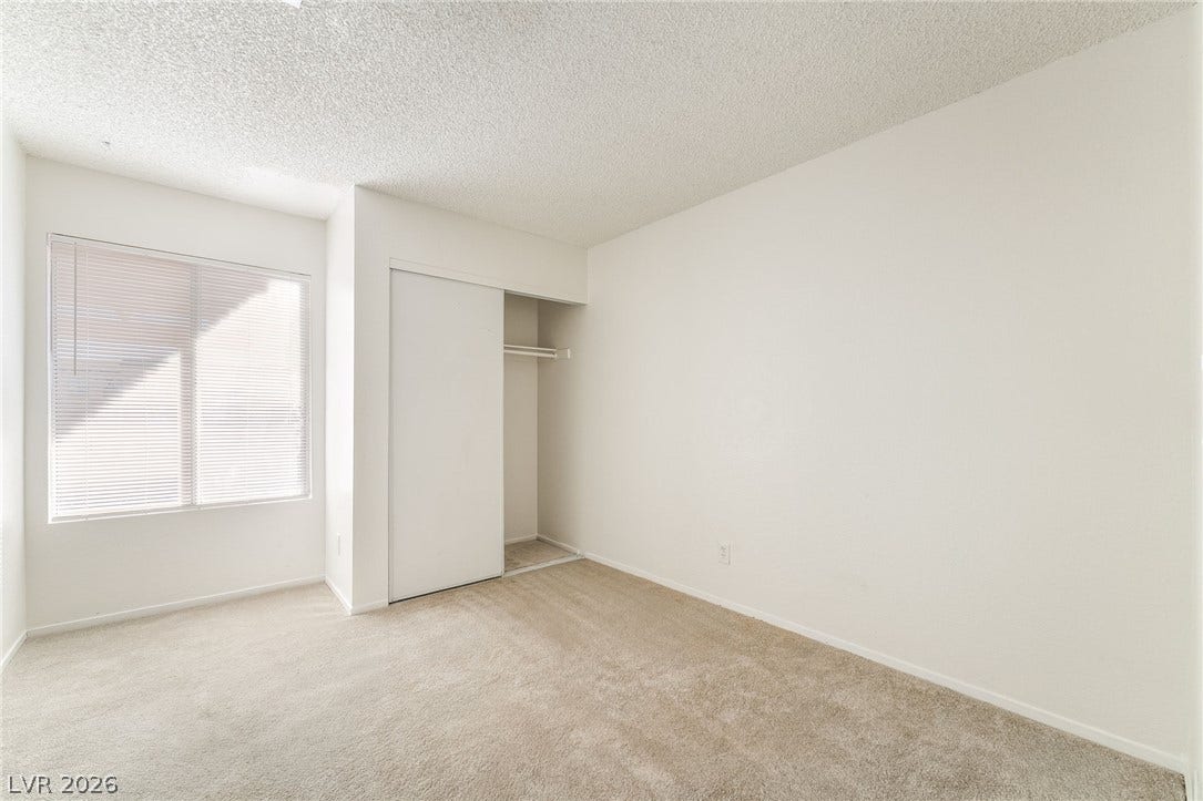 768 Panhandle Drive, Henderson, NV 89014 Plush carpeting and a large window create a comfortable and inviting atmosphere.