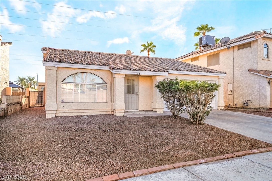 768 Panhandle Drive, Henderson, NV 89014 An arched front window accents the classic stucco exterior of this single-story desert home.