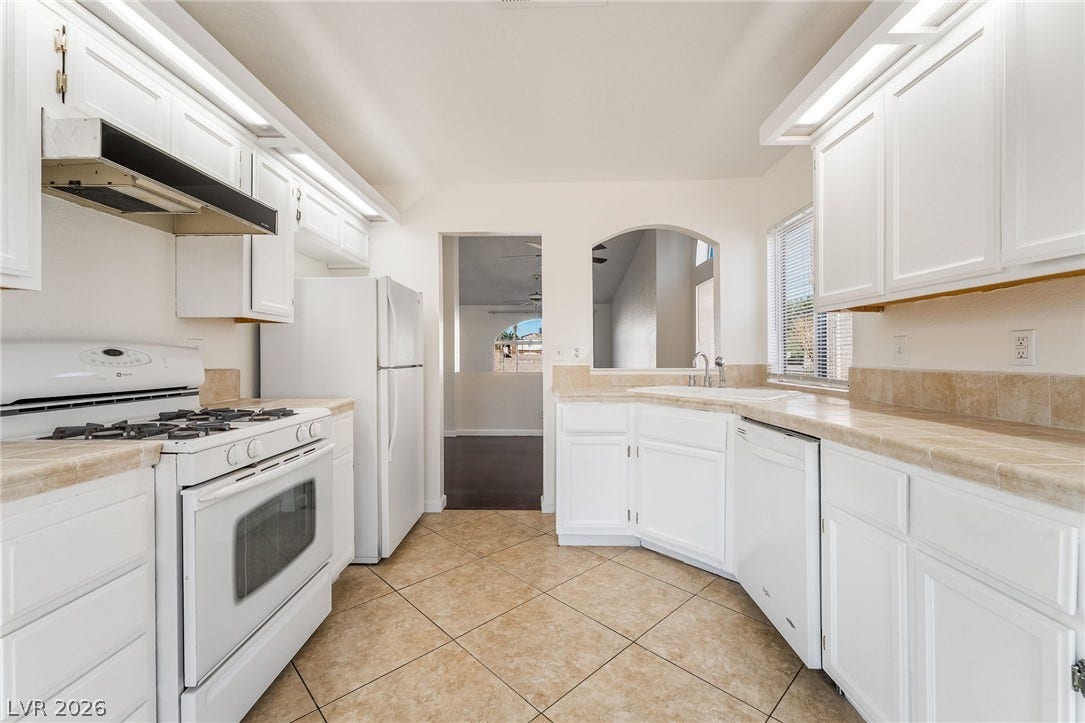 768 Panhandle Drive, Henderson, NV 89014 Crisp white cabinetry pairs with neutral tile flooring in this classic kitchen design.