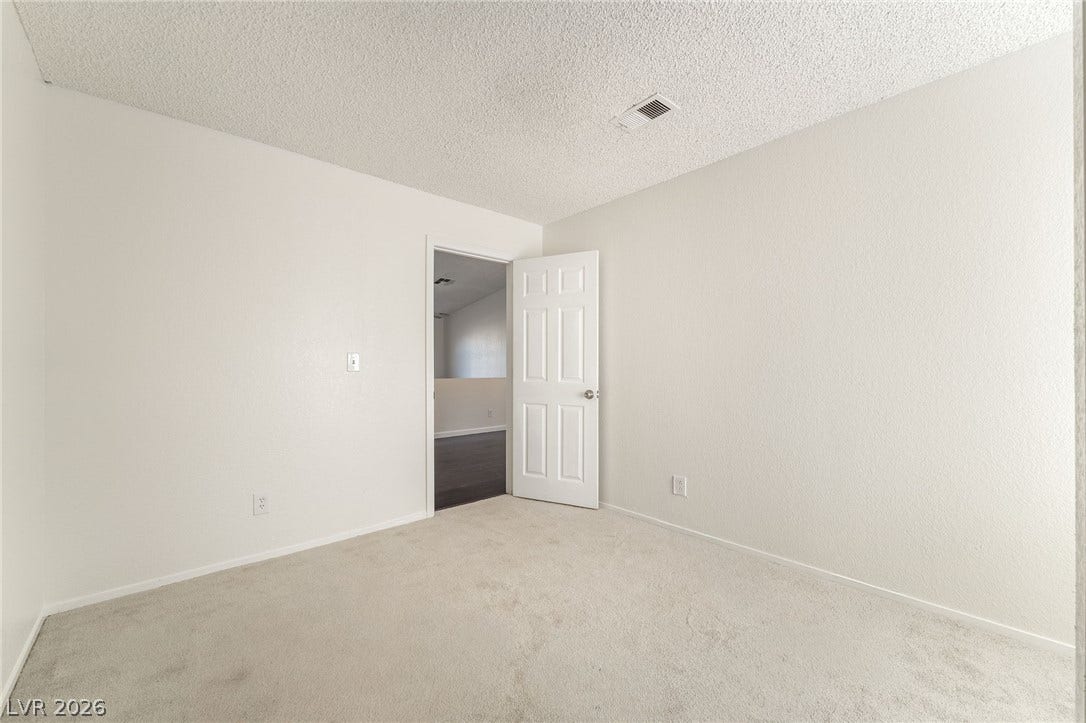 768 Panhandle Drive, Henderson, NV 89014 Plush neutral carpeting and freshly painted walls define this versatile secondary bedroom space.