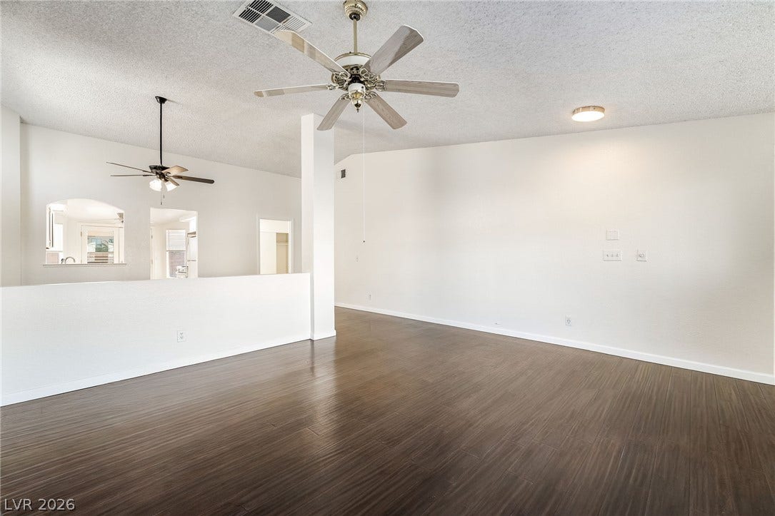 768 Panhandle Drive, Henderson, NV 89014 Rich wood-look flooring and vaulted ceilings define this airy living space.