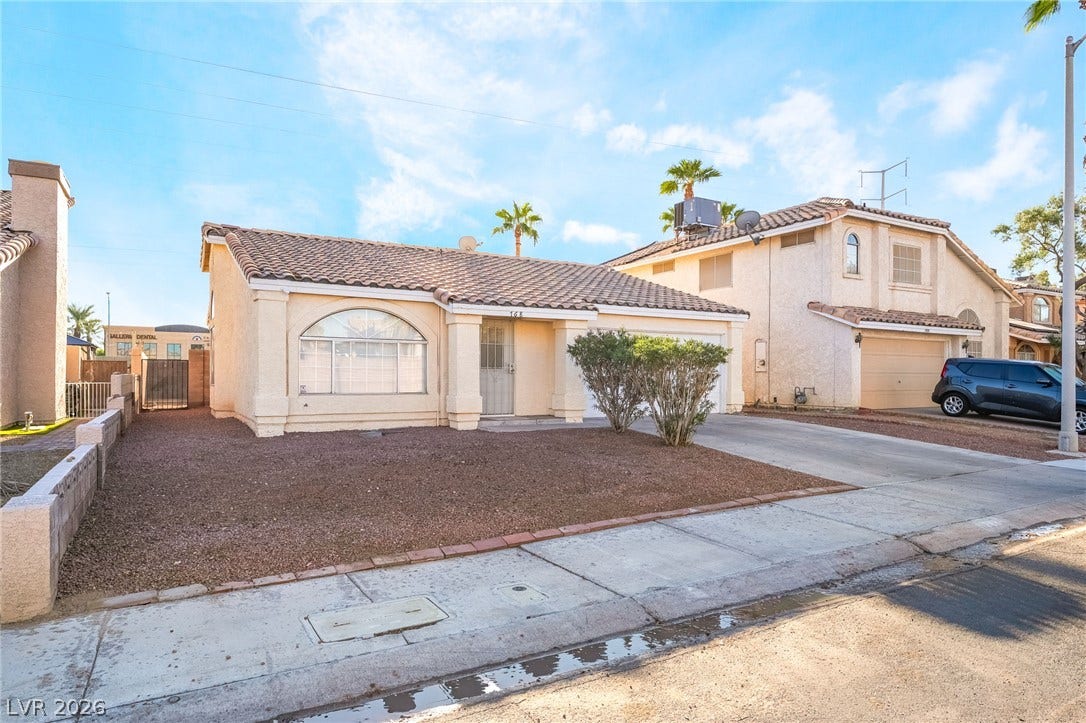 768 Panhandle Drive, Henderson, NV 89014 Spanish tile roofing and stucco siding define this classic single-story desert home.