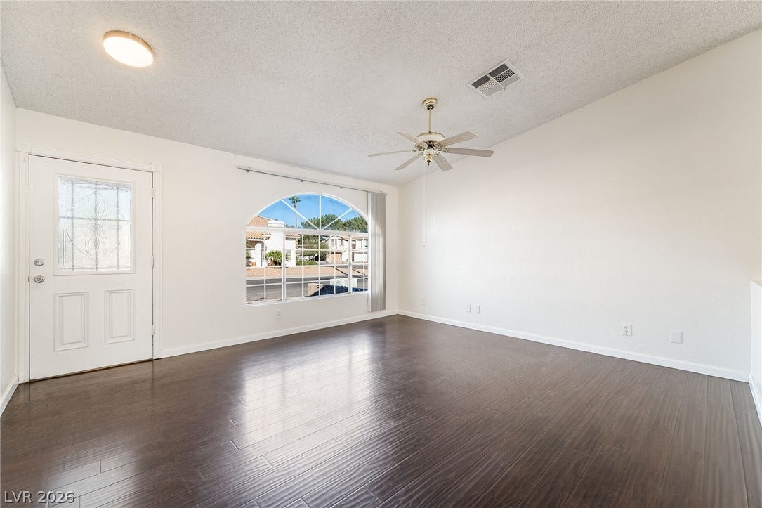 768 Panhandle Drive, Henderson, NV 89014 Gleaming wood floors anchor this versatile room illuminated by an arched display window.