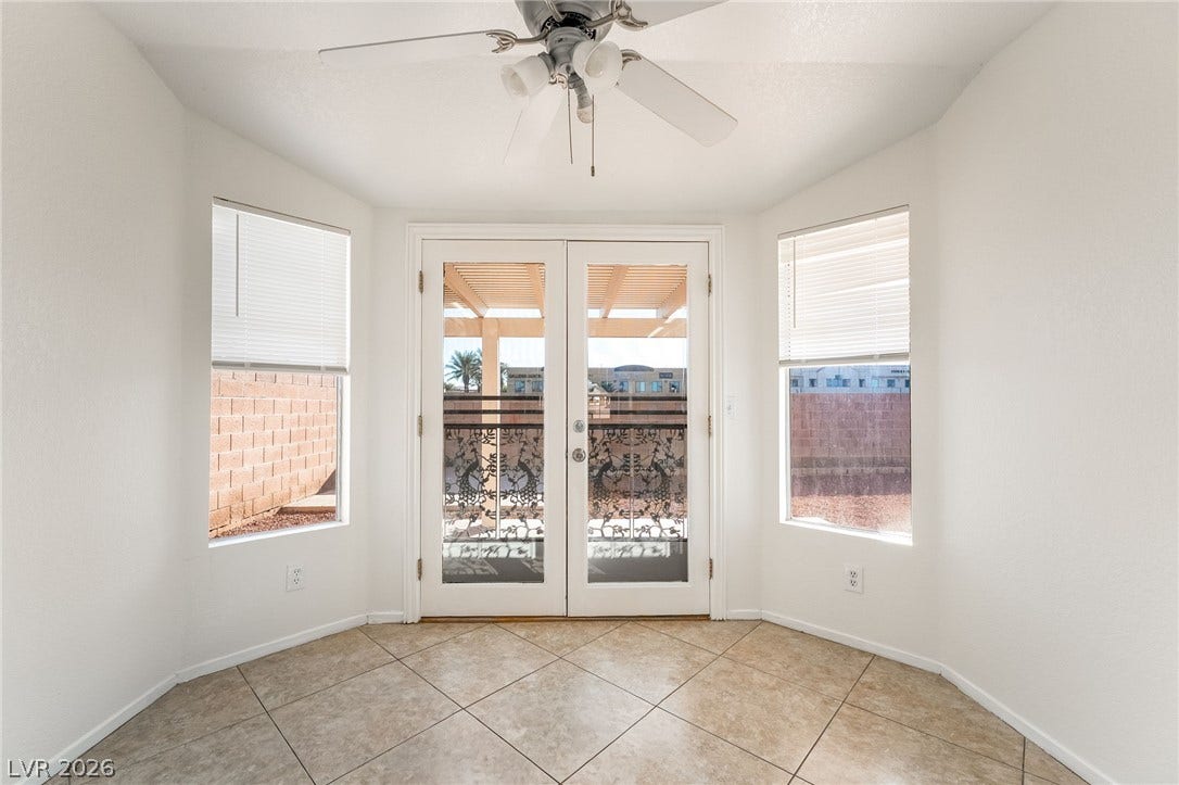 768 Panhandle Drive, Henderson, NV 89014 Tiled flooring and natural light from flanking windows frame elegant double doors to the patio.