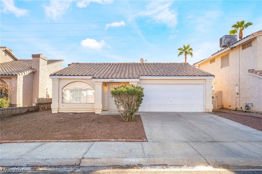 768 Panhandle Drive, Henderson, NV 89014 A classic tiled roof and arched window accent this single-level home with an attached garage.