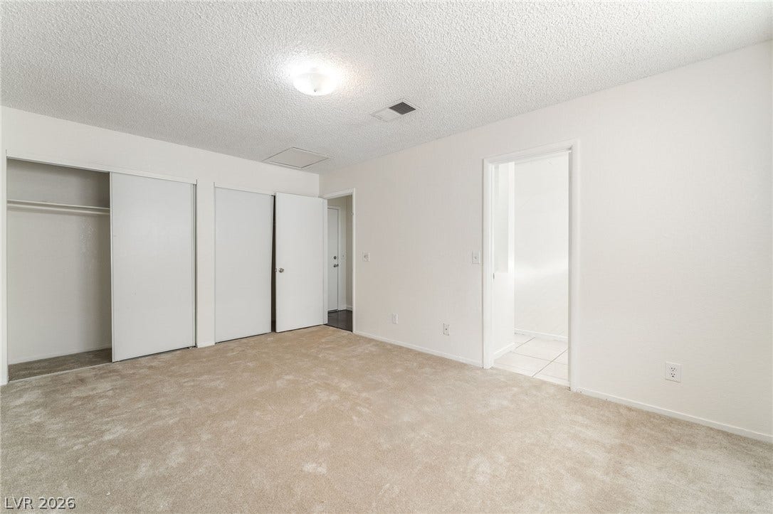 768 Panhandle Drive, Henderson, NV 89014 Plush carpeting and dual closets ground this functional bedroom space.