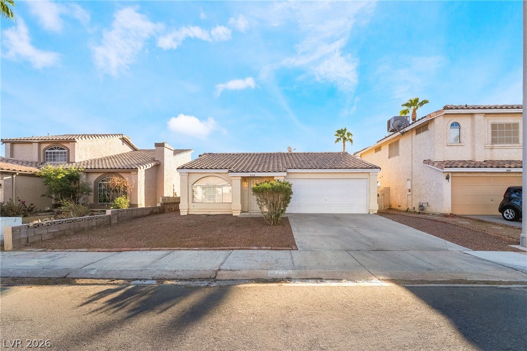 768 Panhandle Drive, Henderson, NV 89014 A classic tiled roof and paved driveway define this single-story suburban residence.
