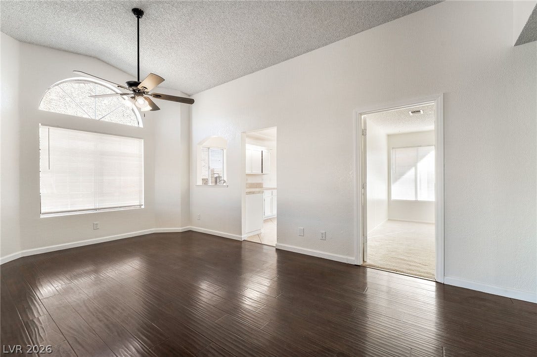 768 Panhandle Drive, Henderson, NV 89014 Rich dark wood flooring complements the airy vaulted ceiling and arched window detailing.