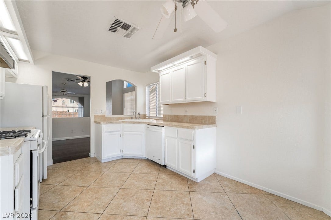 768 Panhandle Drive, Henderson, NV 89014 Tiled flooring and matching cabinetry define this functional culinary space with open sightlines.