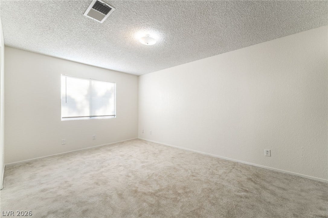768 Panhandle Drive, Henderson, NV 89014 Soft carpeting underfoot and an abundance of natural light define this versatile room.