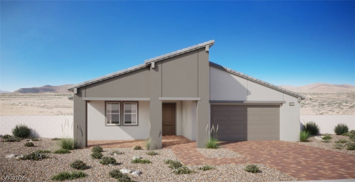 Clean architectural lines and a paver driveway define this modern single-story desert home.