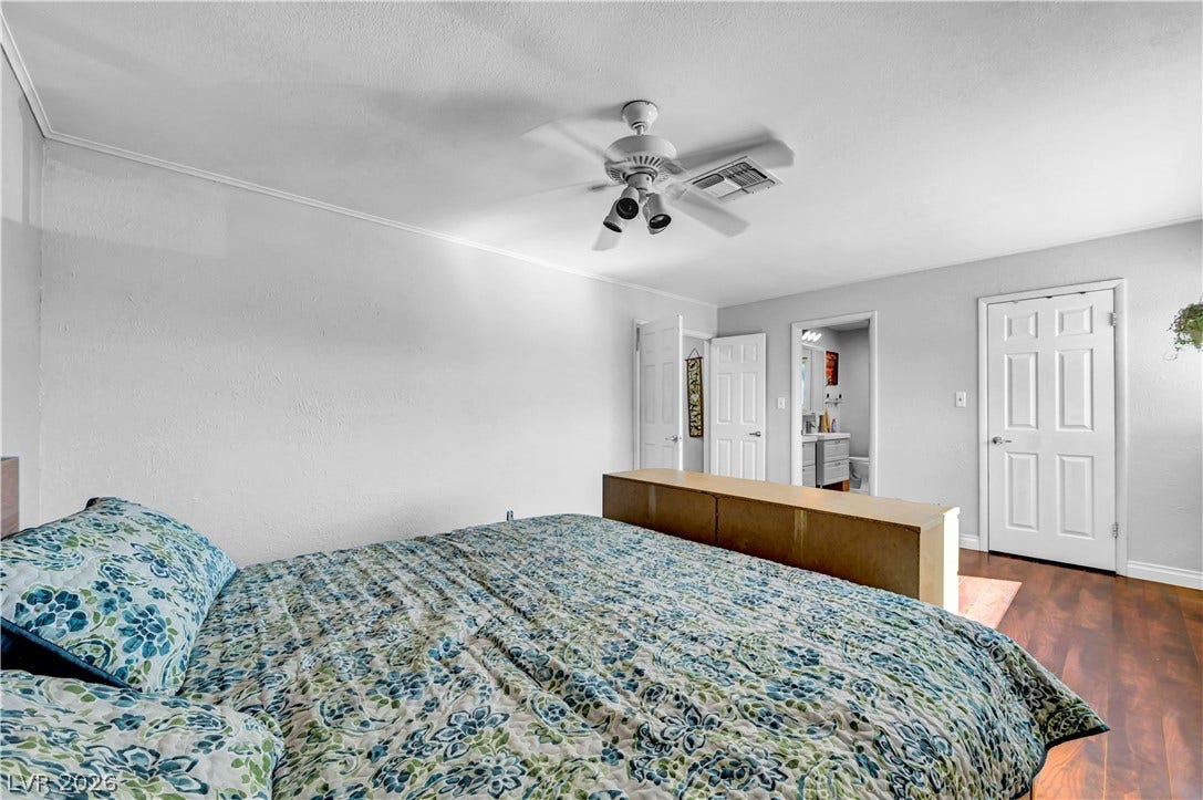342 Fuente Drive, Henderson, NV 89014 Gleaming wood floors anchor this comfortable bedroom setting.