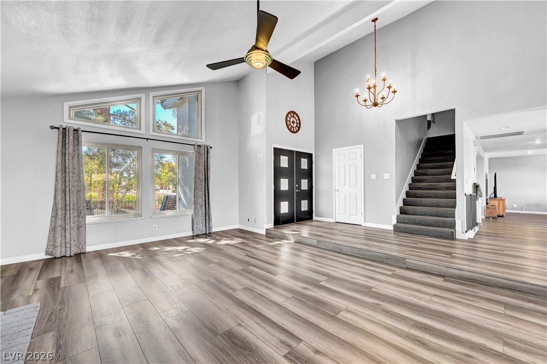 342 Fuente Drive, Henderson, NV 89014 Dramatic vaulted ceilings and durable wood-look flooring define this open living space.