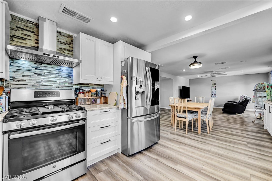342 Fuente Drive, Henderson, NV 89014 Gleaming wood-look floors unite this modernized culinary space with the adjoining dining area.