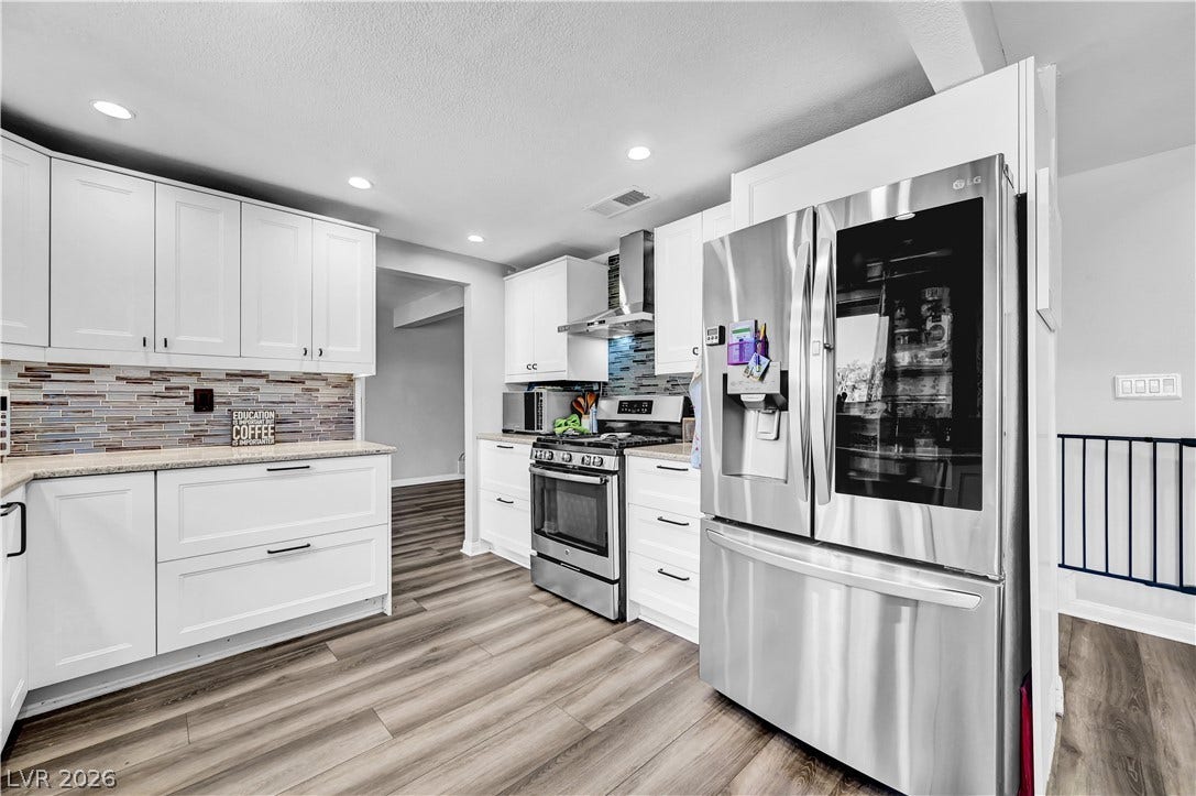 342 Fuente Drive, Henderson, NV 89014 Recessed lighting illuminates this updated kitchen featuring modern countertops and durable wood-look flooring.
