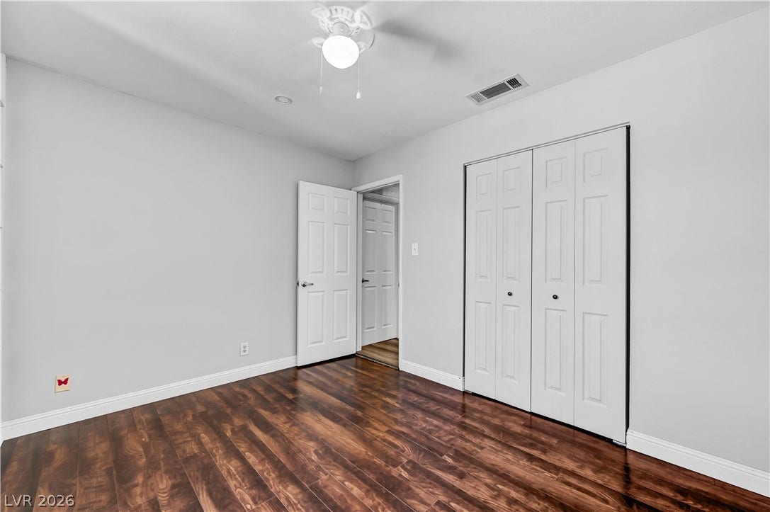 342 Fuente Drive, Henderson, NV 89014 Polished hardwood flooring and clean white trim define this versatile secondary bedroom space.