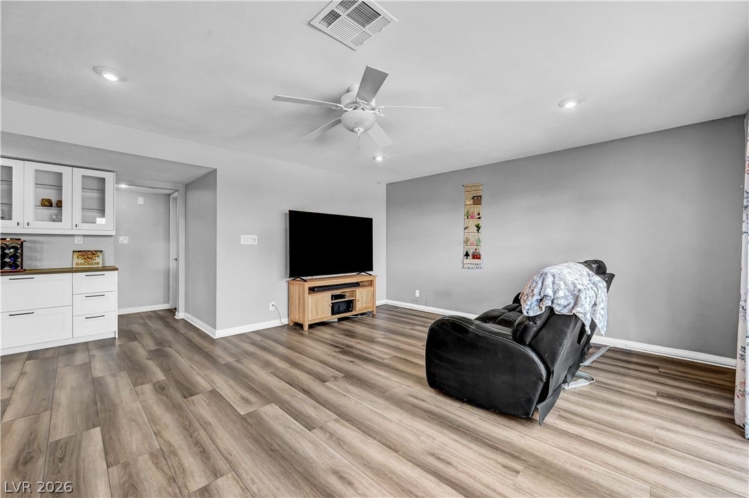 342 Fuente Drive, Henderson, NV 89014 Rich wood-look flooring and recessed lighting define this versatile open living space.