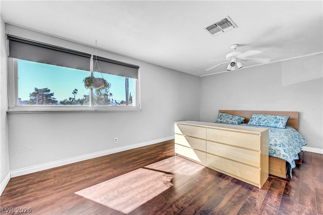 342 Fuente Drive, Henderson, NV 89014 Rich hardwood flooring complements a wide window looking out to scenic views.