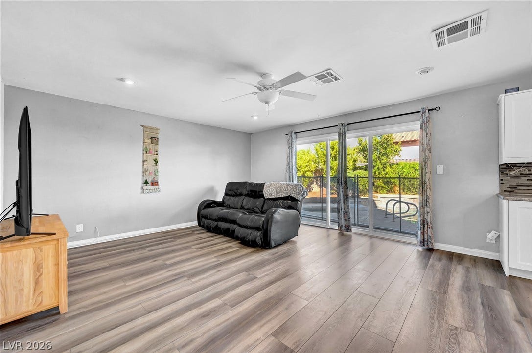 342 Fuente Drive, Henderson, NV 89014 Sliding glass doors open from the living area directly to the backyard pool patio.