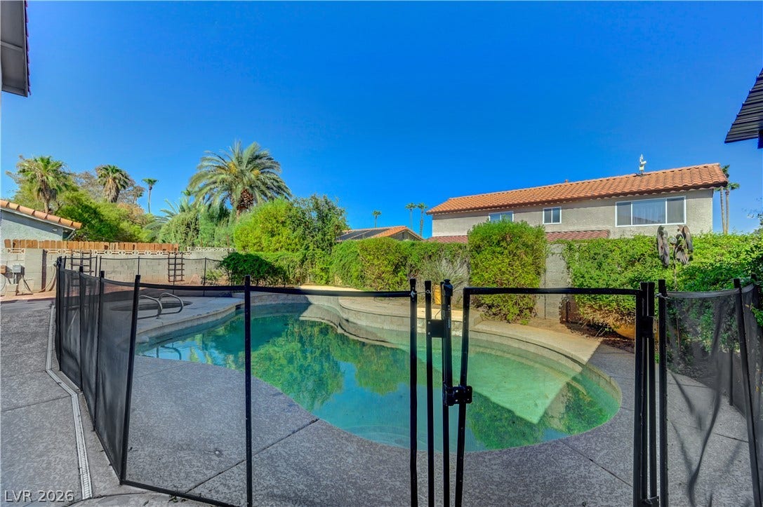 342 Fuente Drive, Henderson, NV 89014 Secure safety fencing surrounds a sparkling in-ground pool set within a private, landscaped backyard.
