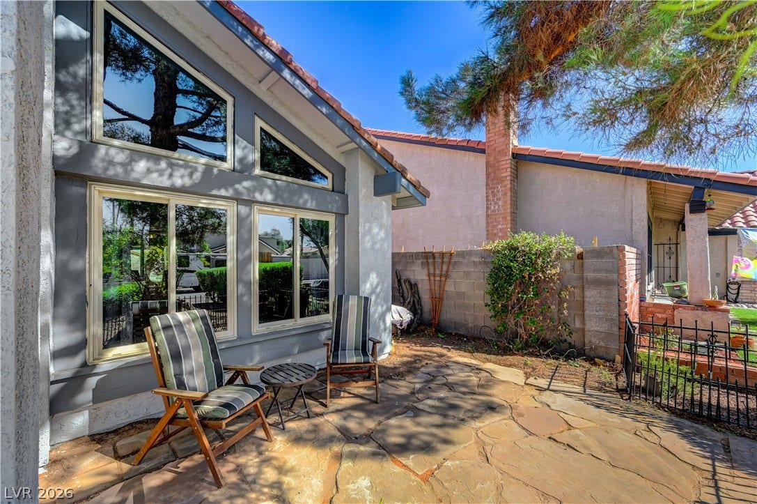342 Fuente Drive, Henderson, NV 89014 Natural flagstone pavers and dramatic high-angled windows define this private outdoor seating area.