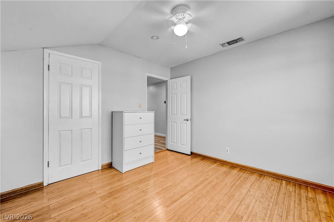 342 Fuente Drive, Henderson, NV 89014 Gleaming wood floors anchor this versatile room featuring a sloped ceiling design.