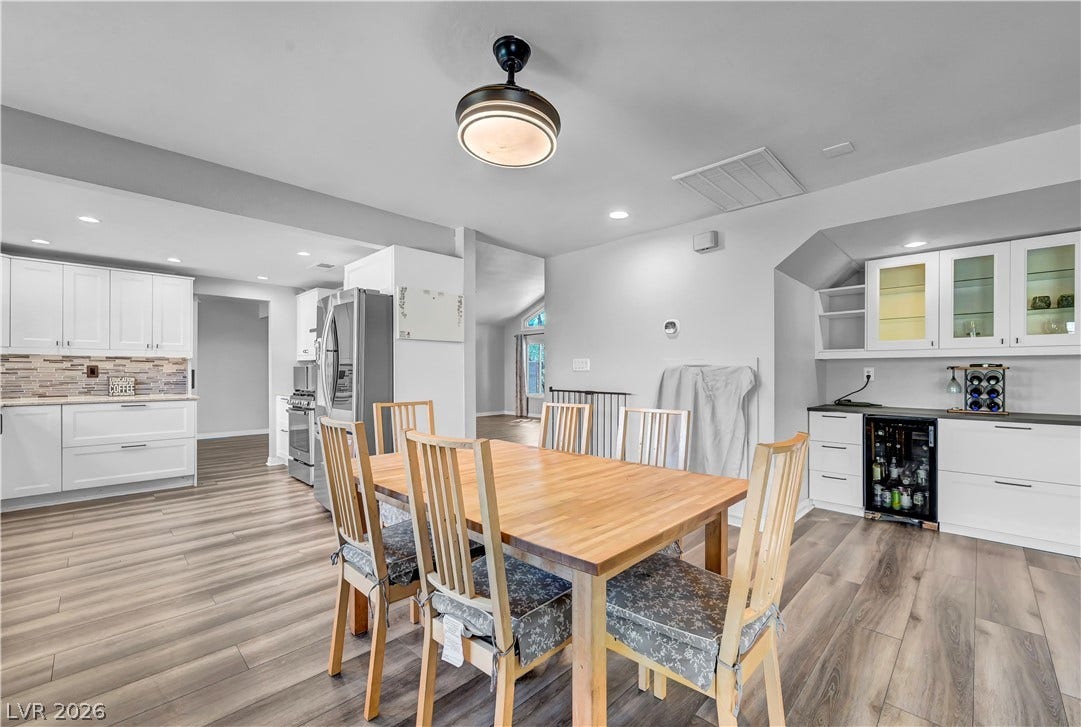 342 Fuente Drive, Henderson, NV 89014 Warm wood flooring extends throughout a versatile dining area flanked by a convenient wet bar.