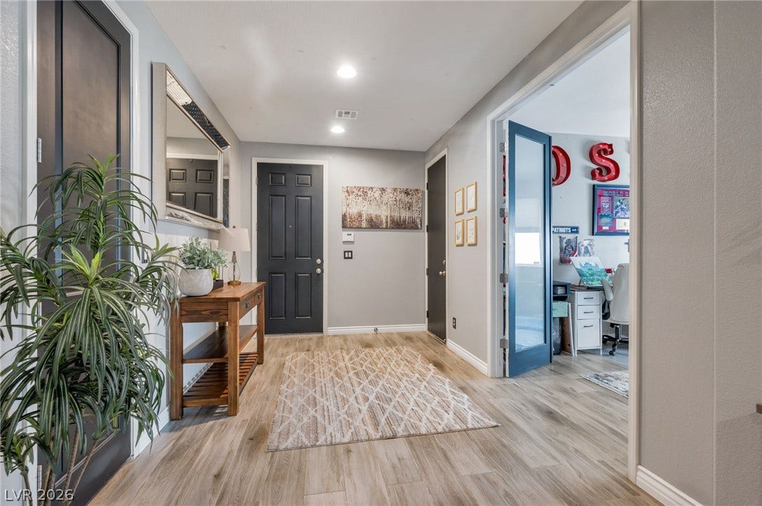 5652 Portage Lake Court, Las Vegas, NV 89130 A well-lit entry hall with wood-look flooring leads to an adjacent home office.