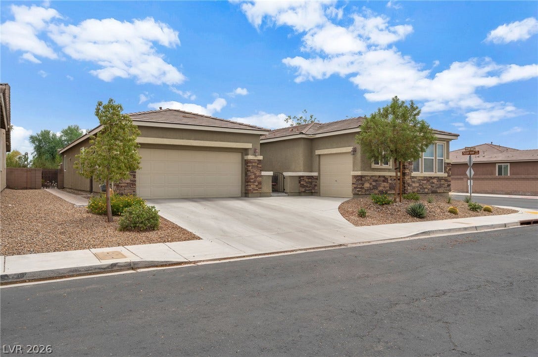 5652 Portage Lake Court, Las Vegas, NV 89130 A desert-friendly landscape surrounds this residence with attached garages and inviting curb appeal.