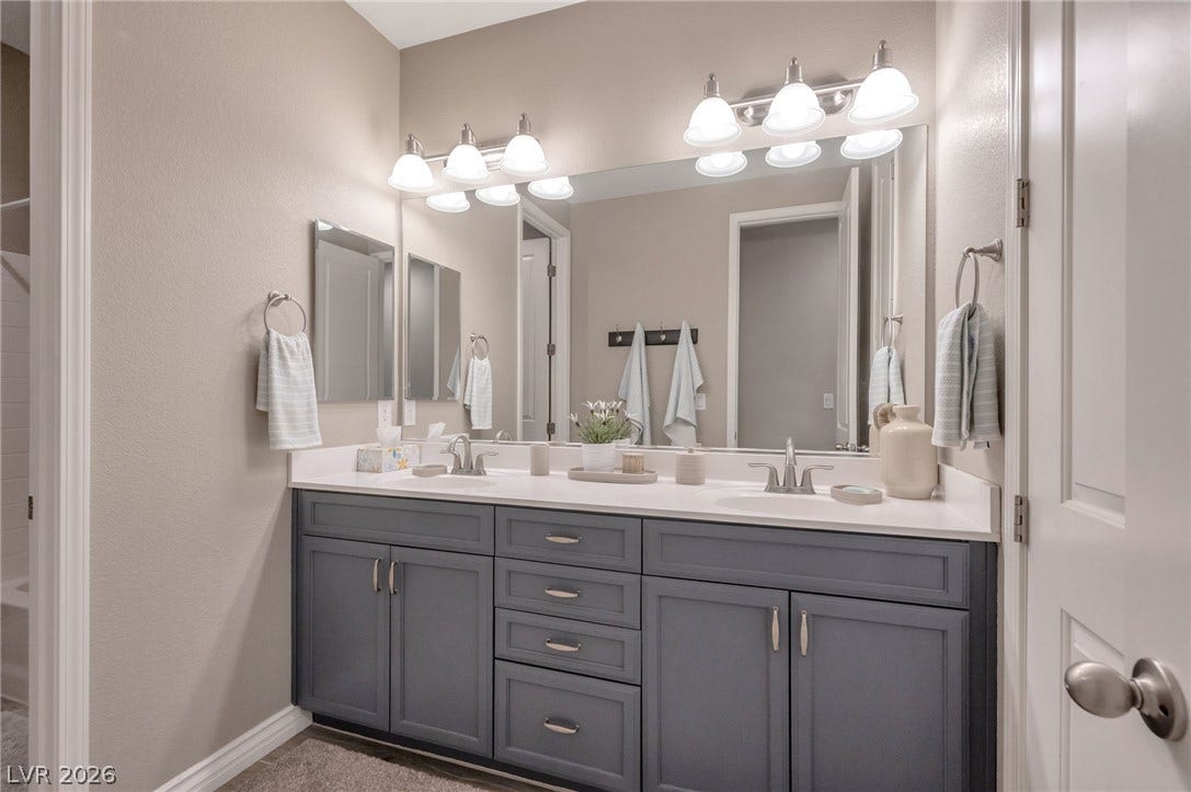 5652 Portage Lake Court, Las Vegas, NV 89130 Dual vanity sinks with ample counter space offer a well-appointed bathroom experience.