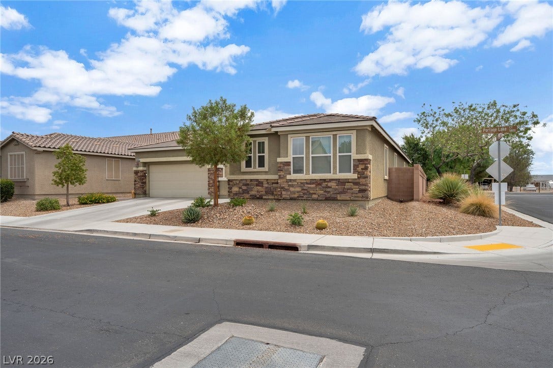 5652 Portage Lake Court, Las Vegas, NV 89130 A well-maintained desert landscape frames this welcoming single-story residence with an attached garage.