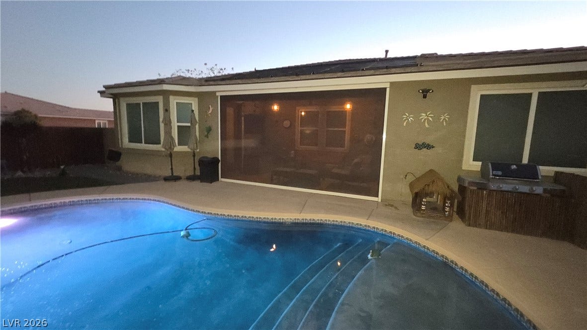 5652 Portage Lake Court, Las Vegas, NV 89130 An inviting private pool beckons next to a screened patio, ideal for evening gatherings.