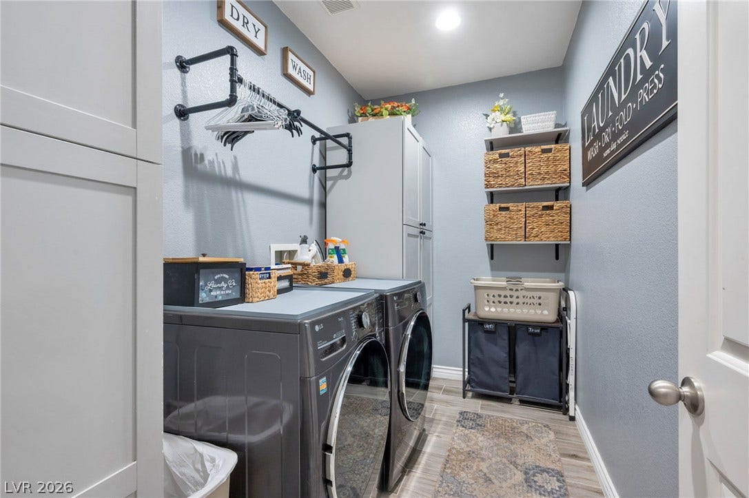 5652 Portage Lake Court, Las Vegas, NV 89130 A well-organized laundry room offers ample storage and modern appliances for efficient chores.