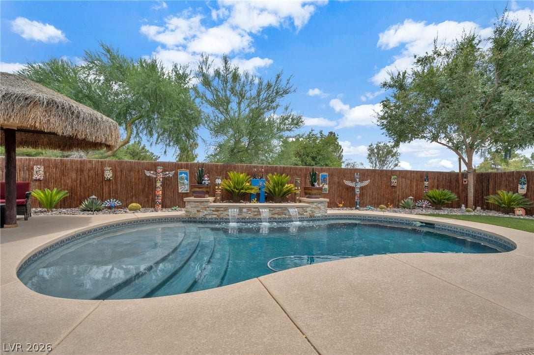 5652 Portage Lake Court, Las Vegas, NV 89130 An inviting private pool and a shaded patio create a serene oasis perfect for relaxation. Bamboo lined property wall.