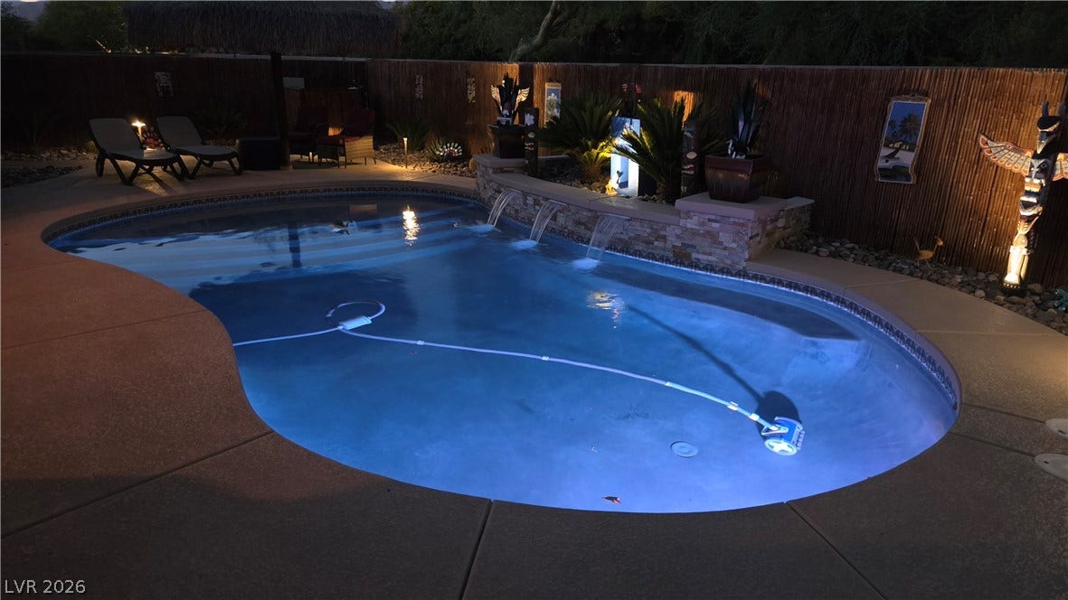 5652 Portage Lake Court, Las Vegas, NV 89130 An inviting backyard oasis offers a freeform pool with luminous blue waters and a serene waterfall feature.