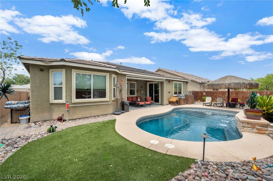5652 Portage Lake Court, Las Vegas, NV 89130 A private backyard oasis awaits, featuring a refreshing in-ground pool and ample space for outdoor entertaining.