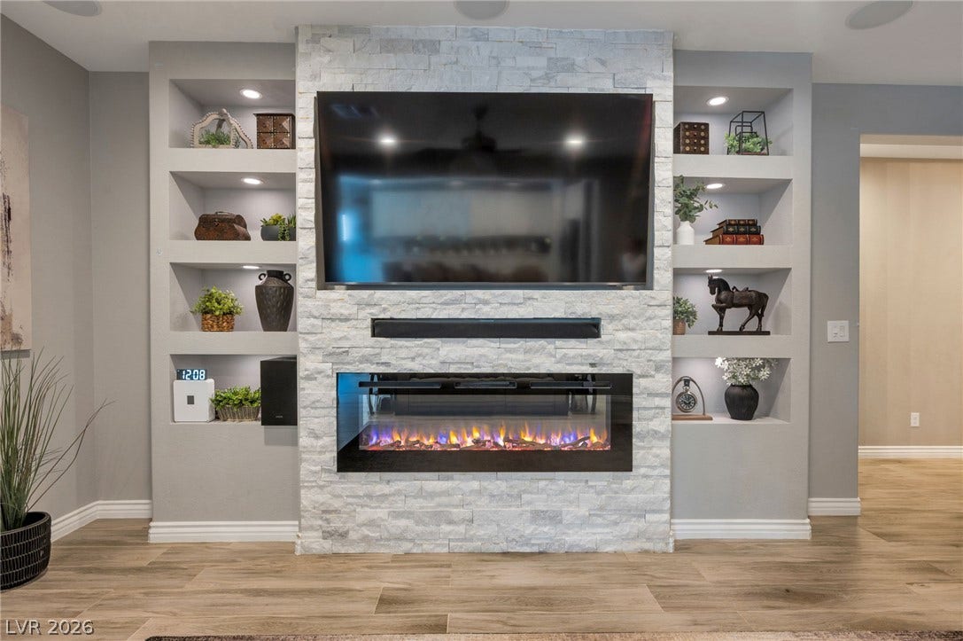 5652 Portage Lake Court, Las Vegas, NV 89130 A striking media wall with an electric fireplace creates a focal point in this living area.