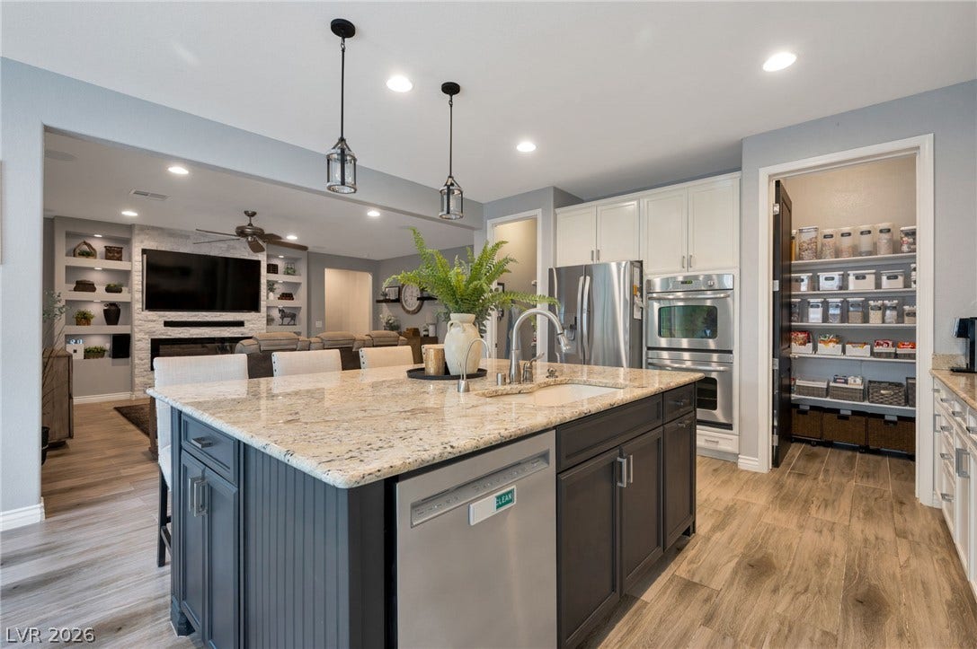 5652 Portage Lake Court, Las Vegas, NV 89130 An open-concept kitchen with a spacious granite island and ample pantry storage flows into a welcoming living area.