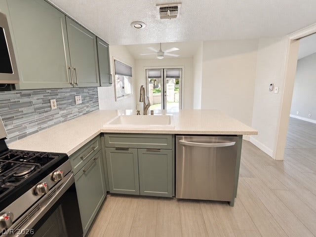 Gleaming stone countertops and modern stainless steel appliances anchor this beautifully updated kitchen.