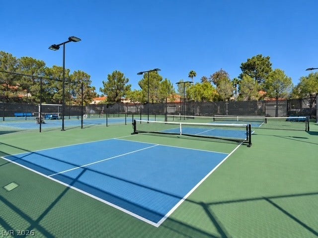 Multiple professionally surfaced pickleball courts stand ready for recreation under clear blue skies.