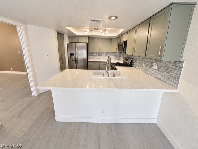 Modern stone countertops and ample cabinet storage define this updated kitchen workspace.