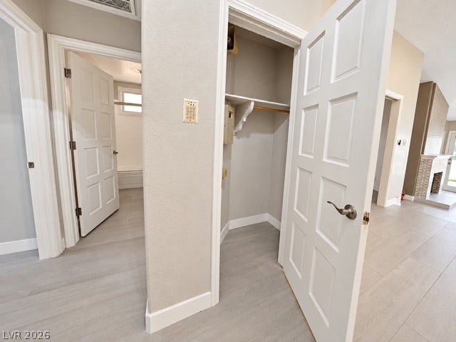 Crisp white trim and light wood-look flooring enhance this functional hallway storage area.