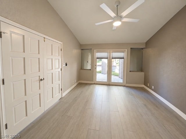 Vaulted ceilings and wood-look flooring enhance this versatile living space opening to the outdoors.