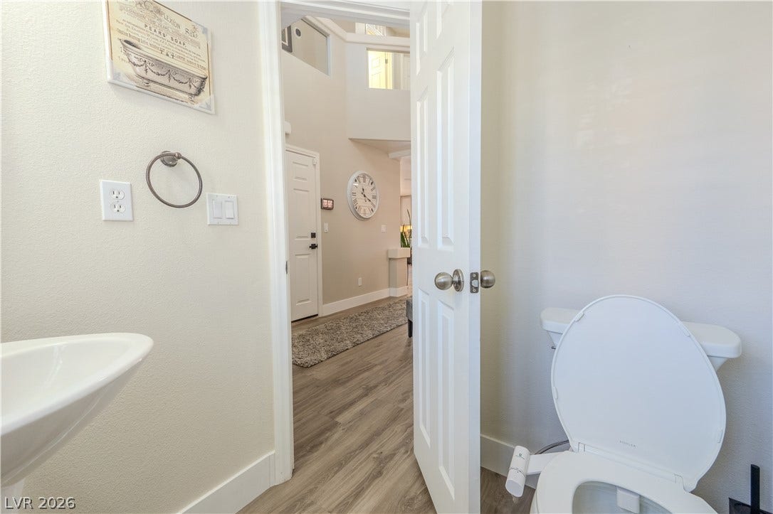 6007 Sonoma Station Avenue, Las Vegas, NV 89139 An open doorway reveals seamless transition from the bath to wood-look flooring.