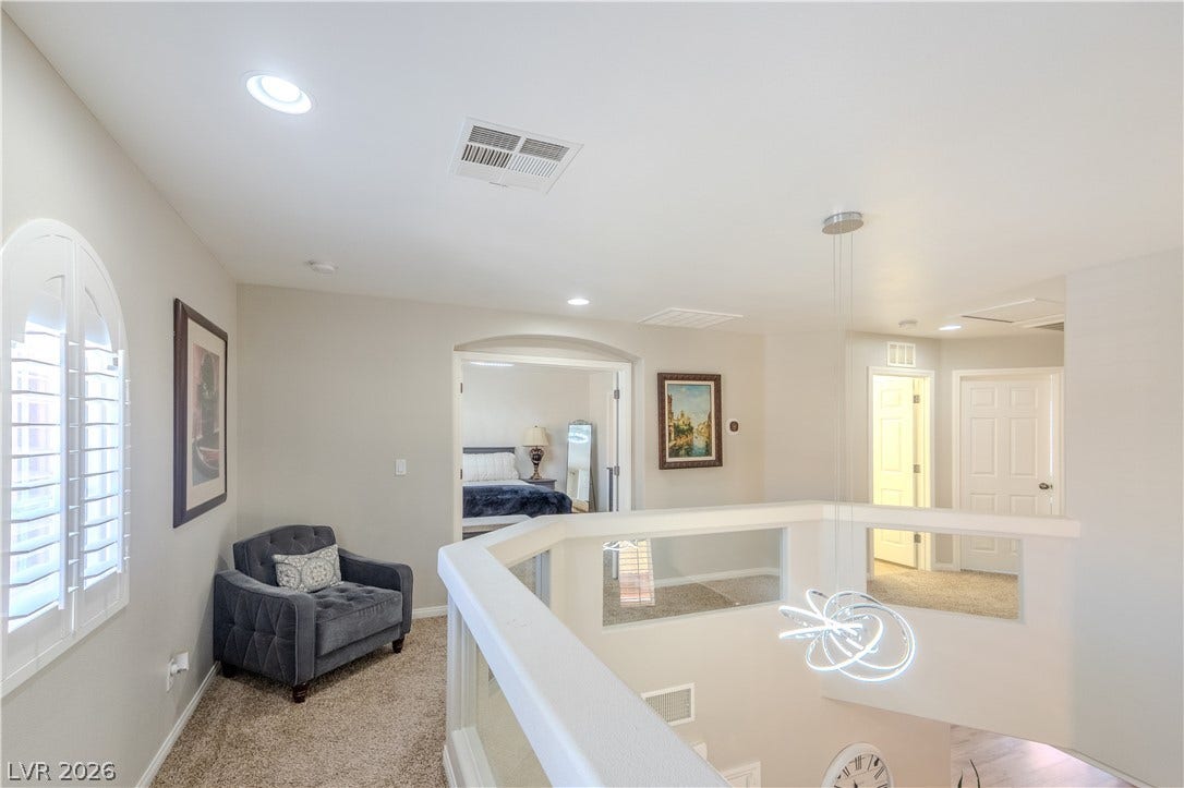 6007 Sonoma Station Avenue, Las Vegas, NV 89139 An airy upper-level landing overlooks the lower floor and features soft carpeted flooring.