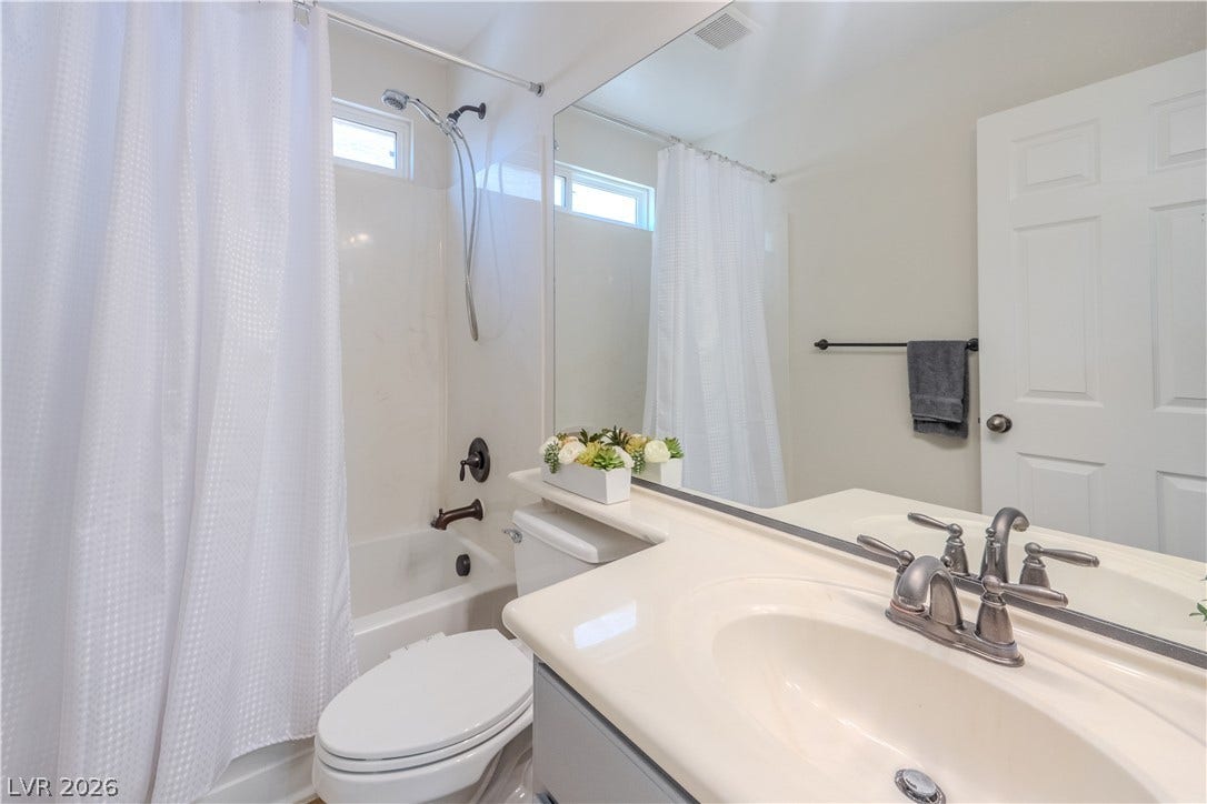 6007 Sonoma Station Avenue, Las Vegas, NV 89139 A clean vanity and a integrated tub-and-shower combination define this functional space.