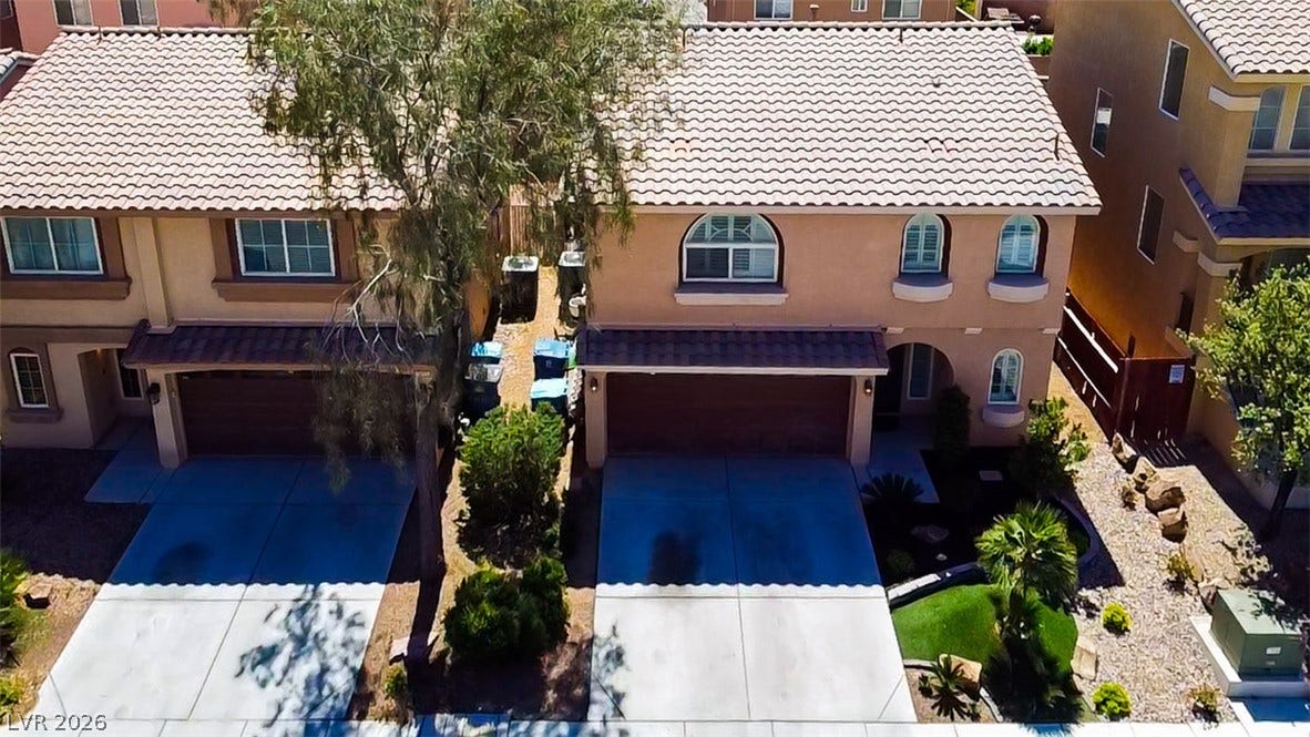 6007 Sonoma Station Avenue, Las Vegas, NV 89139 Spanish tile roofing and concrete driveways define the exterior of these suburban townhomes.